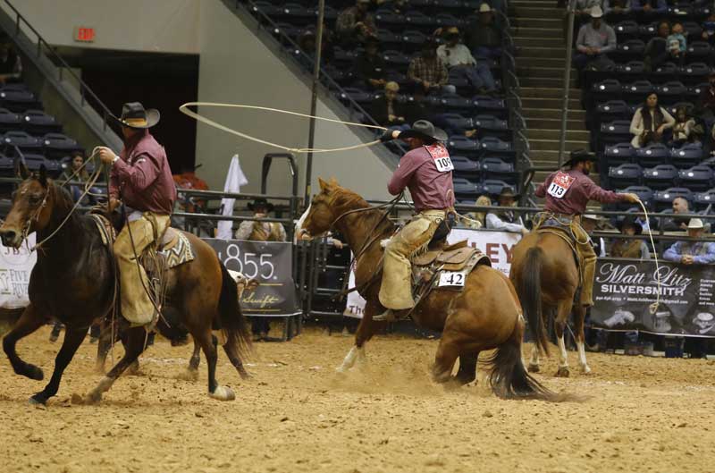 Buster Frierson of the Veale Ranch & Triangle Ranch team, center, displayed some tack of a different kind, riding Whistle Berries Box in a war bridle. The horse is sired by performance sire Snack Box and is owned by Buster.