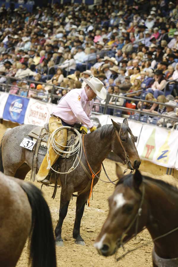 Kris Wilson of the Silver Spur Ranch-Bell Division thanks his partner, Lil Wholly Pepto, for a nice run in the team penning. If you’ll notice the orange tie-string around the horse’s neck and the orange ribbon on Kris’ shirt sleeve, you’ll realize that breast cancer wasn’t the only focus on Friday night. Orange is the signature color for kidney cancer awareness. Kris is fighting kidney cancer, with the help of the Working Ranch Cowboys Foundation, and is grateful that he has been able to compete with his team.