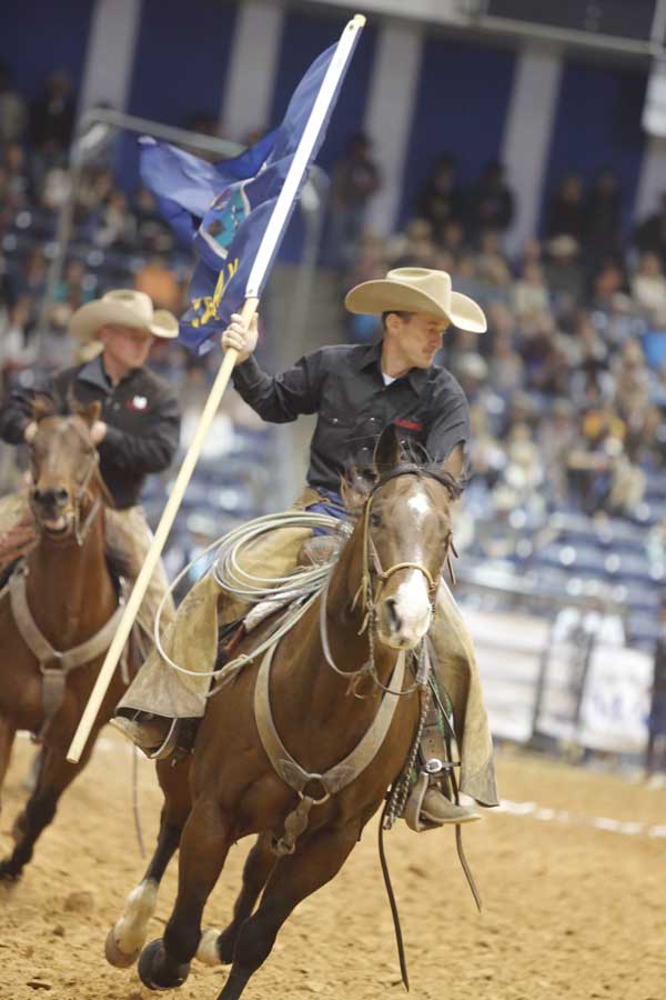 Clint Donley of the Lazy B Ranch presents his state’s colors in Saturday night’s opening ceremonies.